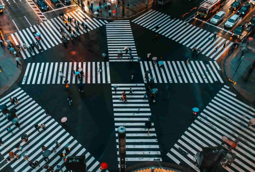 Shibuya Crossing in Tokyo, Japan, bustling with people and neon lights.